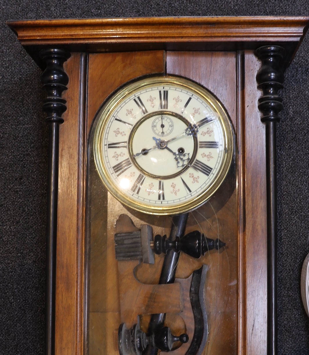 A late 19th century part ebonized walnut Vienna type wall clock, circular dial with subsidiary seconds, height 92 cms